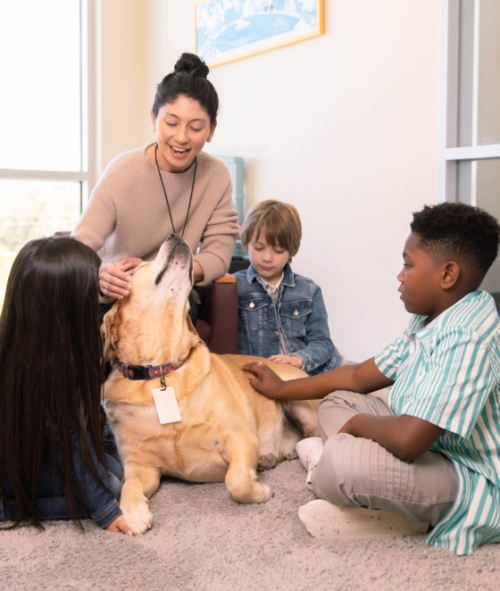 Lady with young kids and big dog in the center for child protection