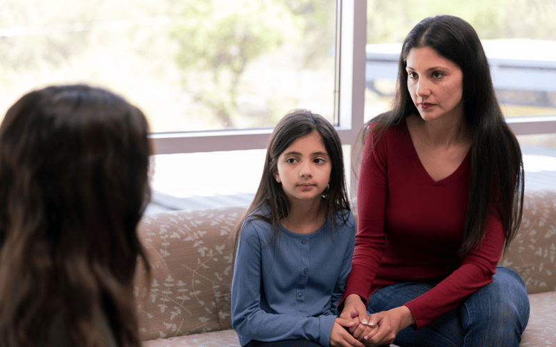 child sitting with parent talking to family advocate at the center for child protection